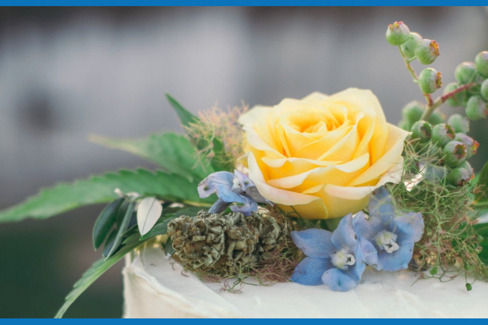 white cannabis cake with flower nug and other flowers for weddings